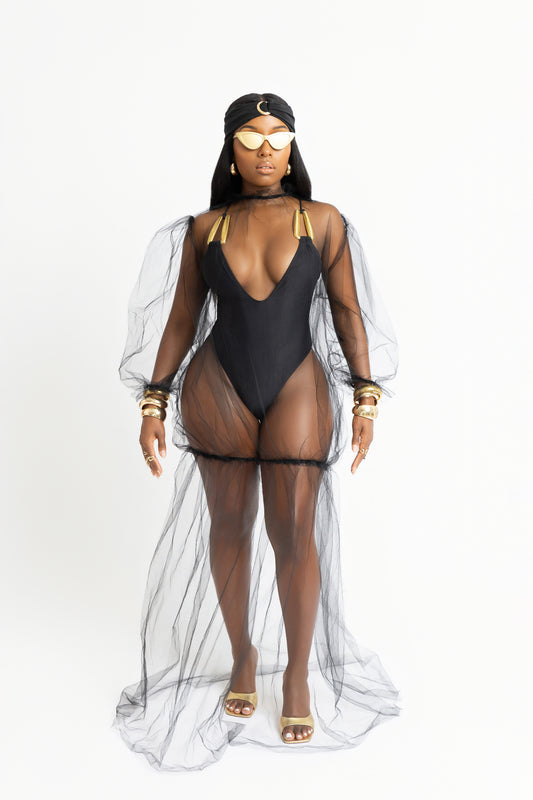 Sheer mesh maxi cover-up inspired by Bali. Floor-length, black, and lightweight with statement sleeves. A bold vacation essential.