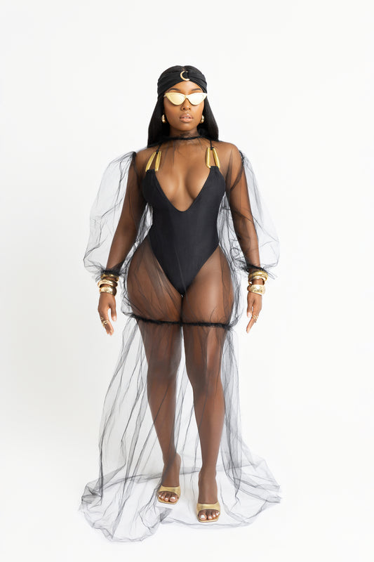 Sheer mesh maxi cover-up inspired by Bali. Floor-length, black, and lightweight with statement sleeves. A bold vacation essential.