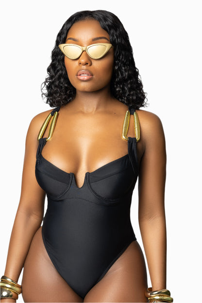 The Monaco Swimsuit features gold hardware, adjustable straps, underwire support, and a flattering cut. Your must-have black one-piece for vacation.